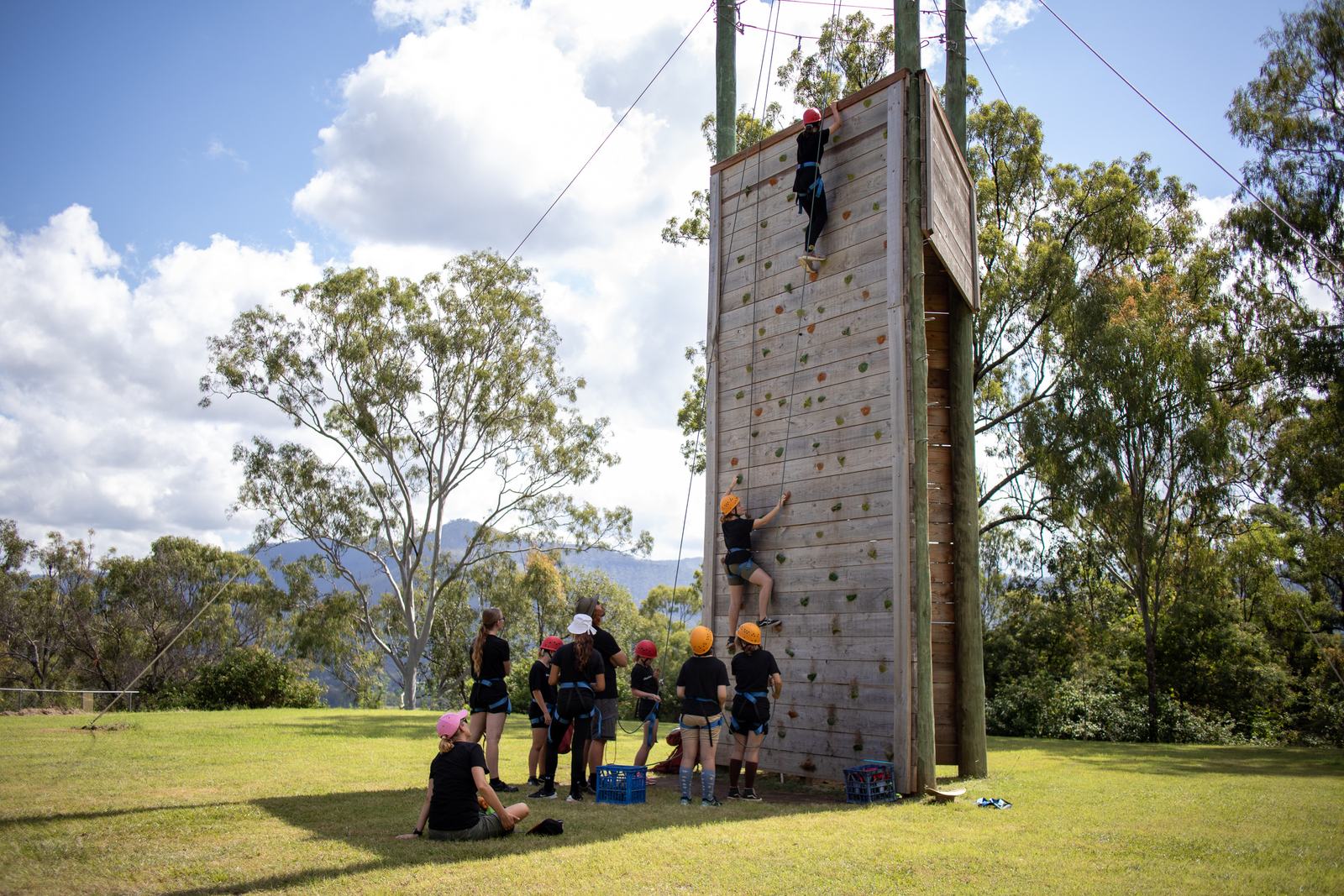 Climbing tower with students at the base